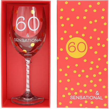 Wine glass with '60 & Sensational' text in a red box with yellow polka dots