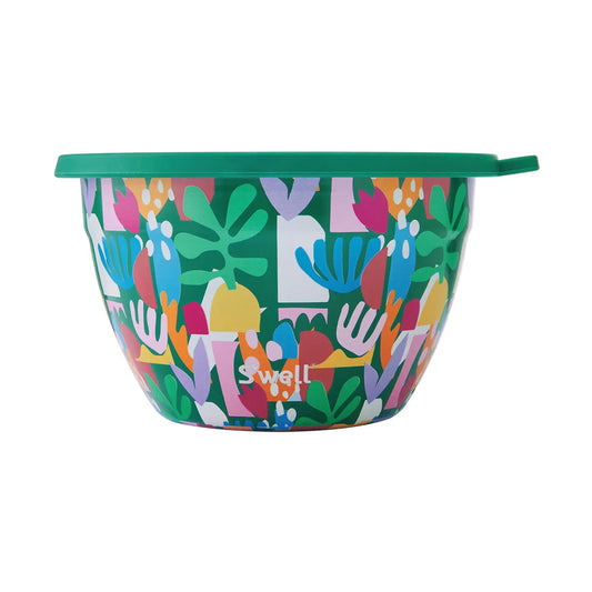 Colorful bowl with abstract design and green lid on a white background