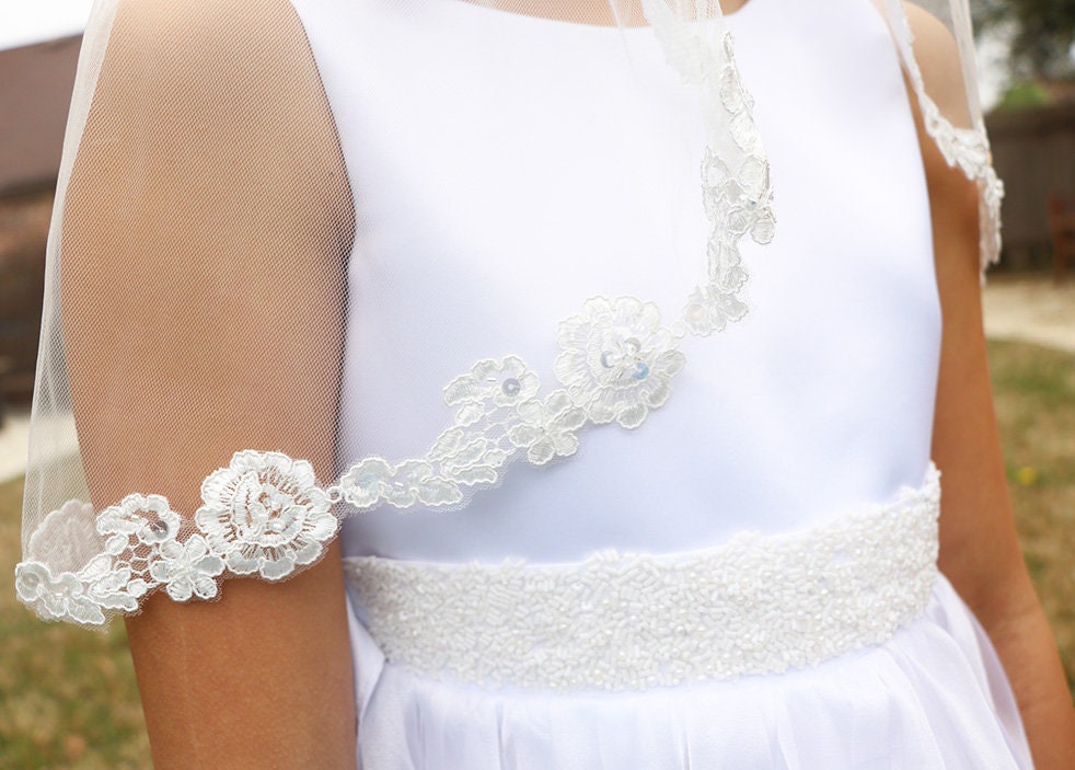 White lace-trimmed dress with a blurred background