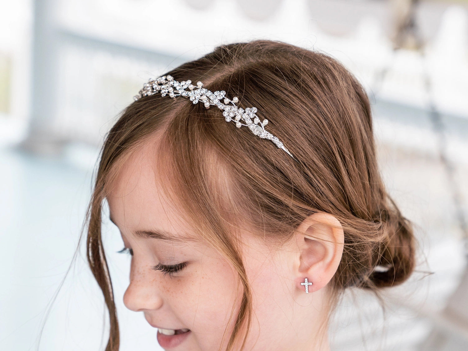 Young girl wearing a decorative headband with a blurred background