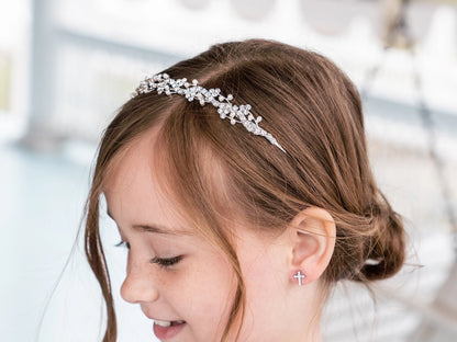 Young girl wearing a decorative headband with a blurred background