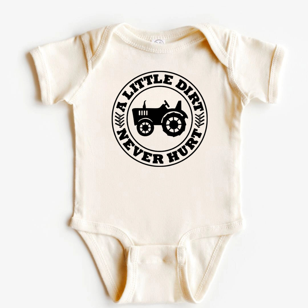 An off-white short-sleeve baby bodysuit with a black circular graphic on the chest featuring a tractor and the text 'A LITTLE DIRT NEVER HUNT'.