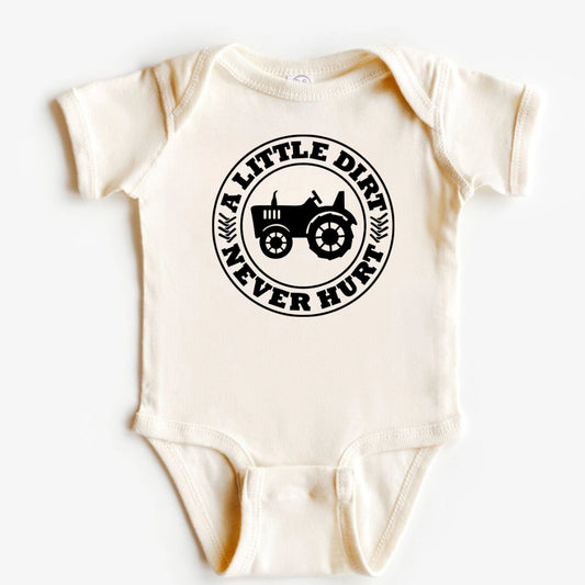 An off-white short-sleeve baby bodysuit with a black circular graphic on the chest featuring a tractor and the text 'A LITTLE DIRT NEVER HUNT'.