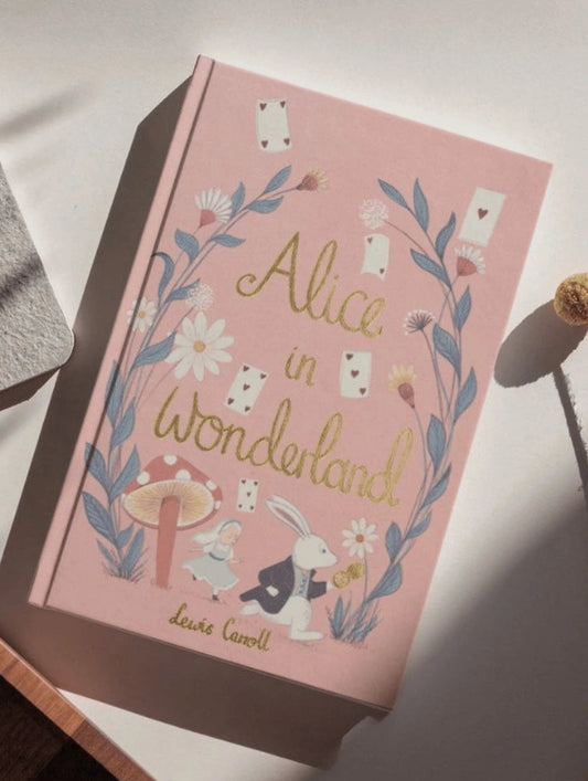 Book cover of 'Alice in Wonderland' with decorative elements on a light background