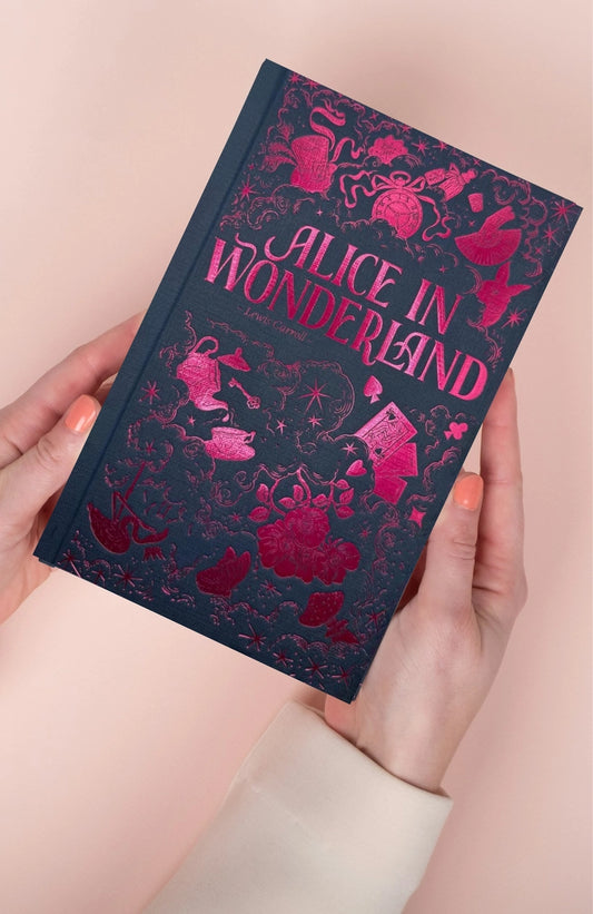 Book titled 'Alice in Wonderland' held by a person with a pink background