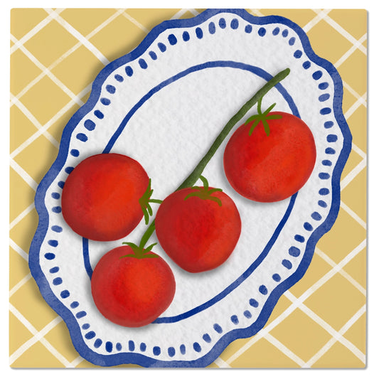Decorative tile with red tomatoes on a white plate with blue rim against a yellow tiled background