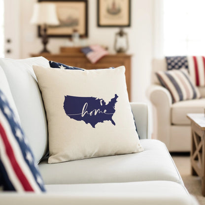 Decorative pillow with 'home' and USA map design on a couch in a living room setting.