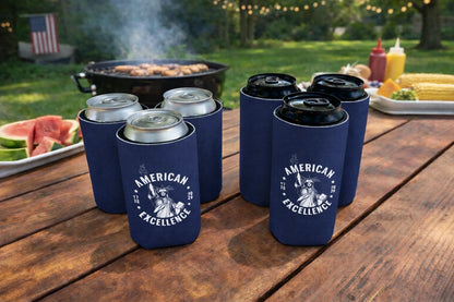 Navy blue can coolers with 'American Excellence' design on a wooden table outdoors.
