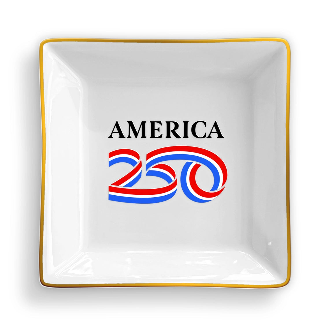 White decorative plate with 'AMERICA 250' text in red and blue, gold rim, on a white background