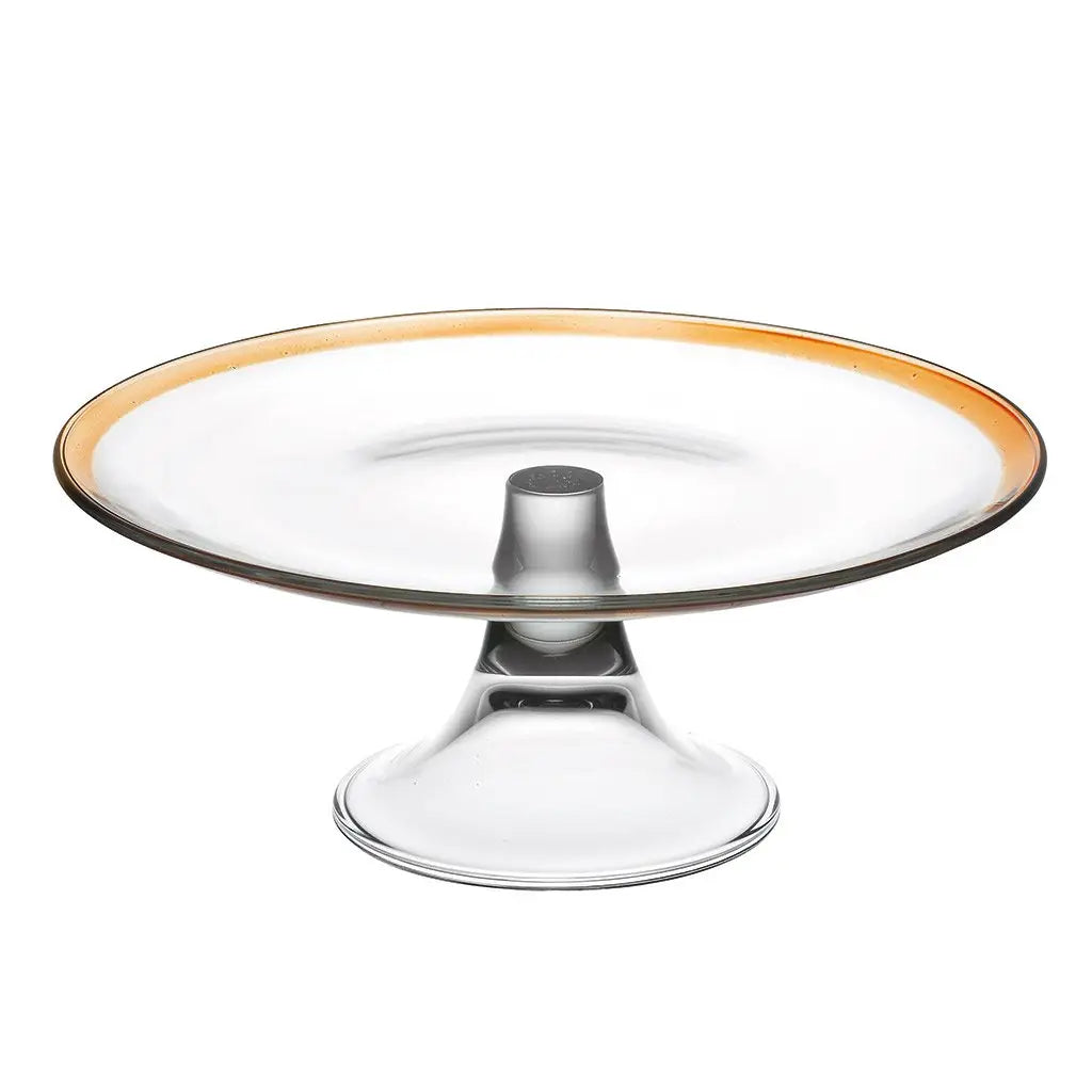 Clear glass cake stand with gold rim on a white background