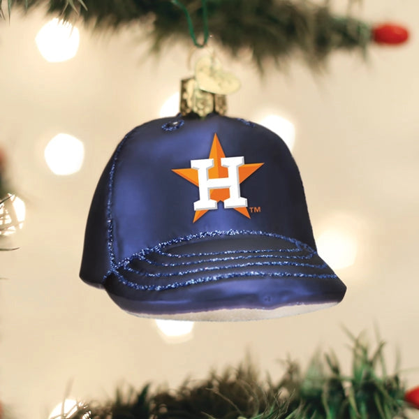 Blue baseball cap ornament with 'H' logo on a Christmas tree.