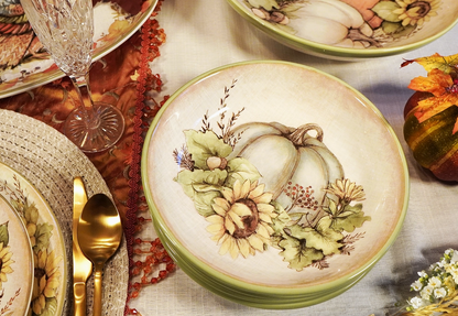 Decorative ceramic plates with autumn-themed designs on a table setting.