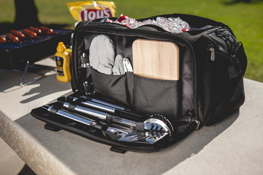 Black barbecue tool set in a carrying case on a table outdoors