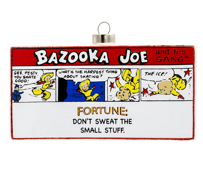 A rectangular hanging ornament featuring a vintage-style comic strip titled 'Bazooka Joe and his Gang' with cartoon characters and the text 'Fortune: Don't Sweat the Small Stuff.' The ornament has a red border, a silver hanging loop, and a white lower section with black and gold text.