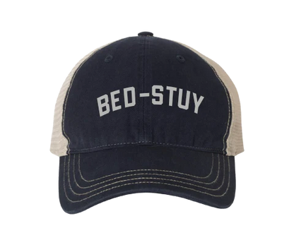 Navy and beige cap with 'BED-STUY' text on a white background