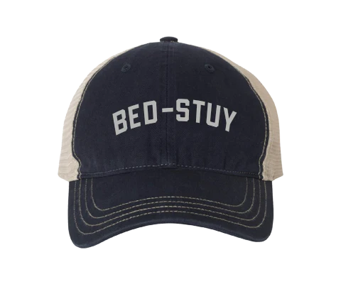 Navy and beige cap with 'BED-STUY' text on a white background