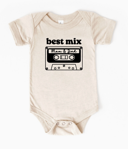 Beige baby onesie with a black cassette tape design and text on a white background