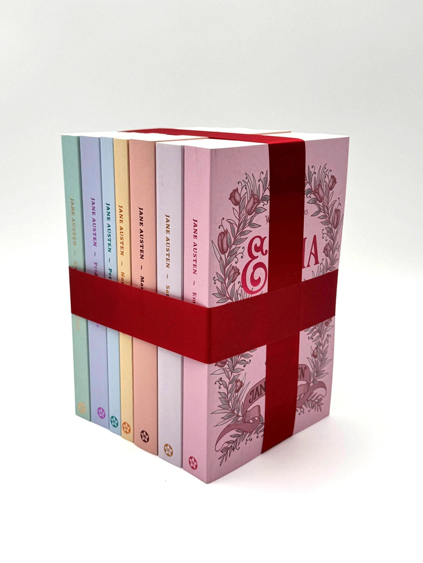 Set of Jane Austen books in a decorative box with a red ribbon on a white background