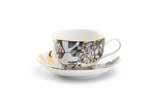 Ceramic cup and saucer with floral design on a white background