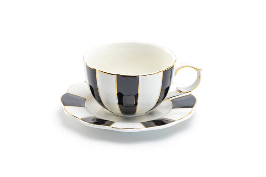 Teacup and saucer with black and white striped design on a white background