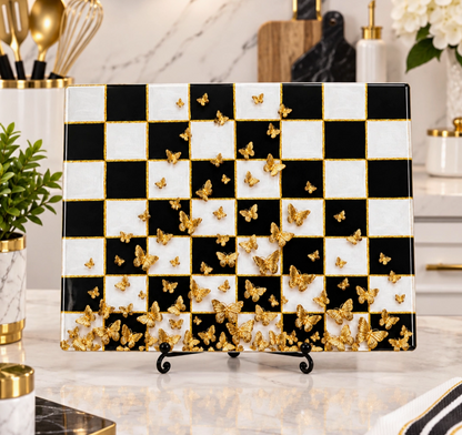 Black and white check glass cutting board with cascading gold butterfly design