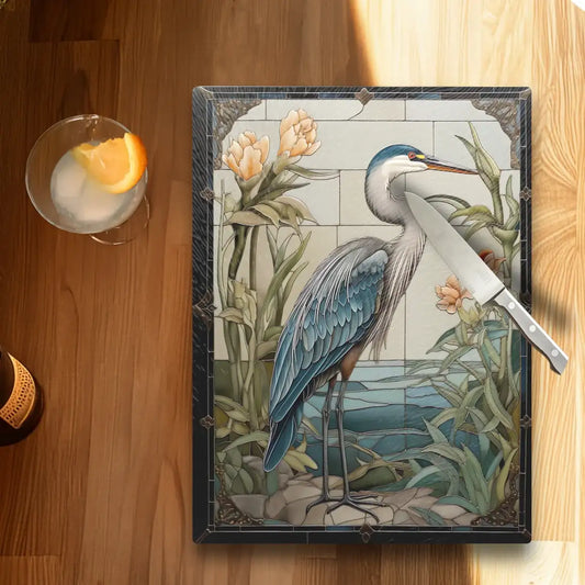 Decorative tile with a heron design on a wooden surface with a cocktail.