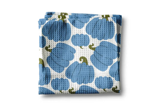 Folded fabric with blue and green pattern on a white background