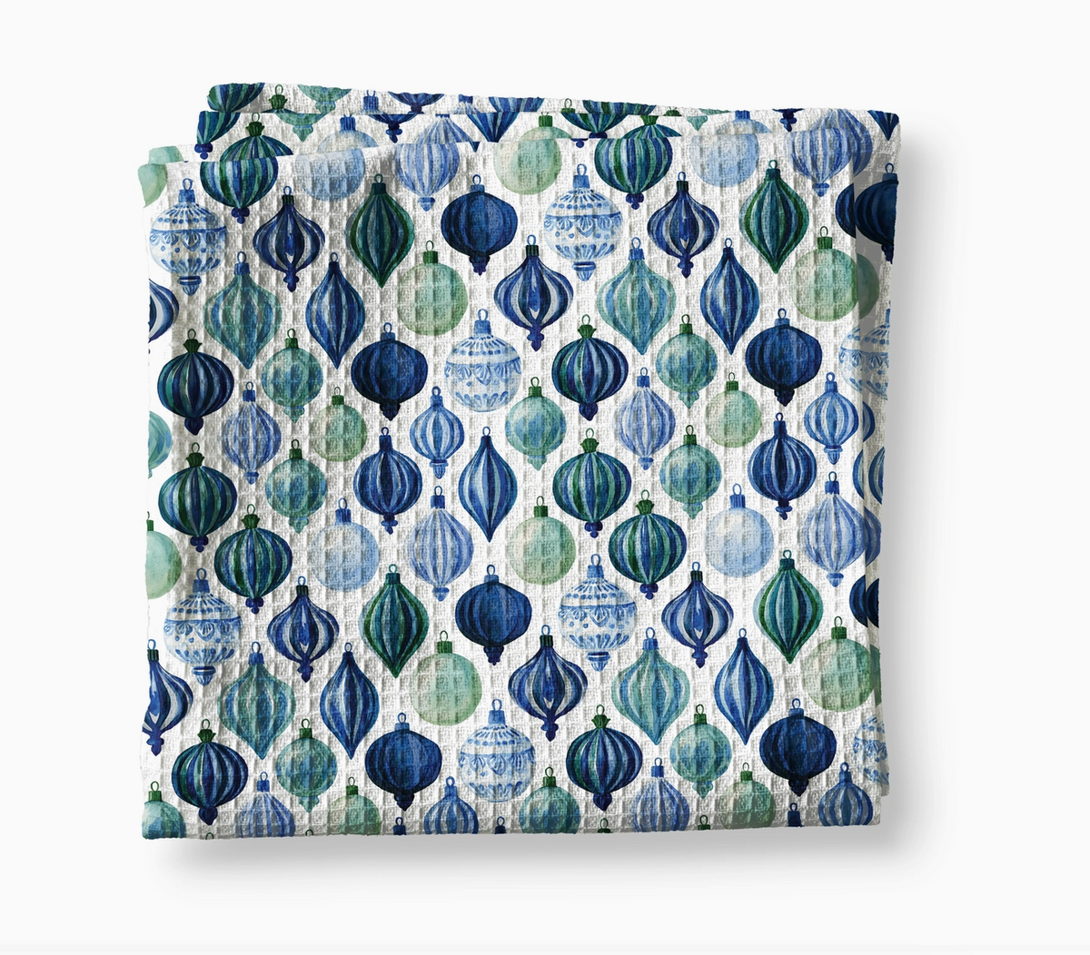 Blue chinoiserie Christmas waffle weave kitchen towel covered in watercolor-style navy, teal, green and light blue holiday ornaments.