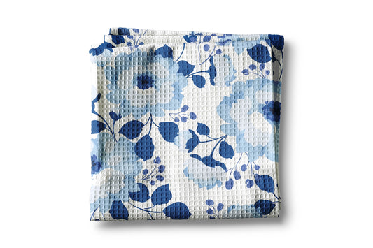 Folded fabric with blue floral pattern on a white background