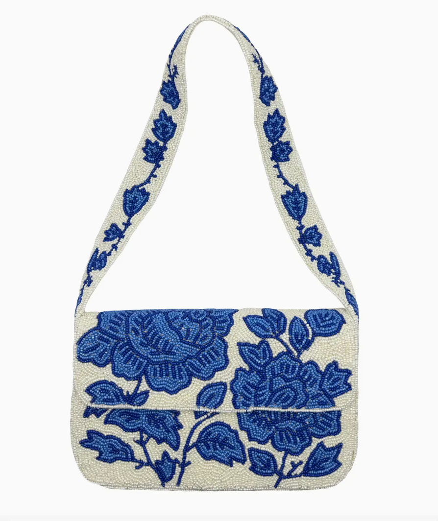 Handbag with blue floral pattern on a white background