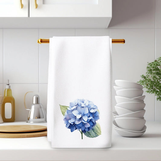 Kitchen towel with blue flower design hanging on a rack in a kitchen.