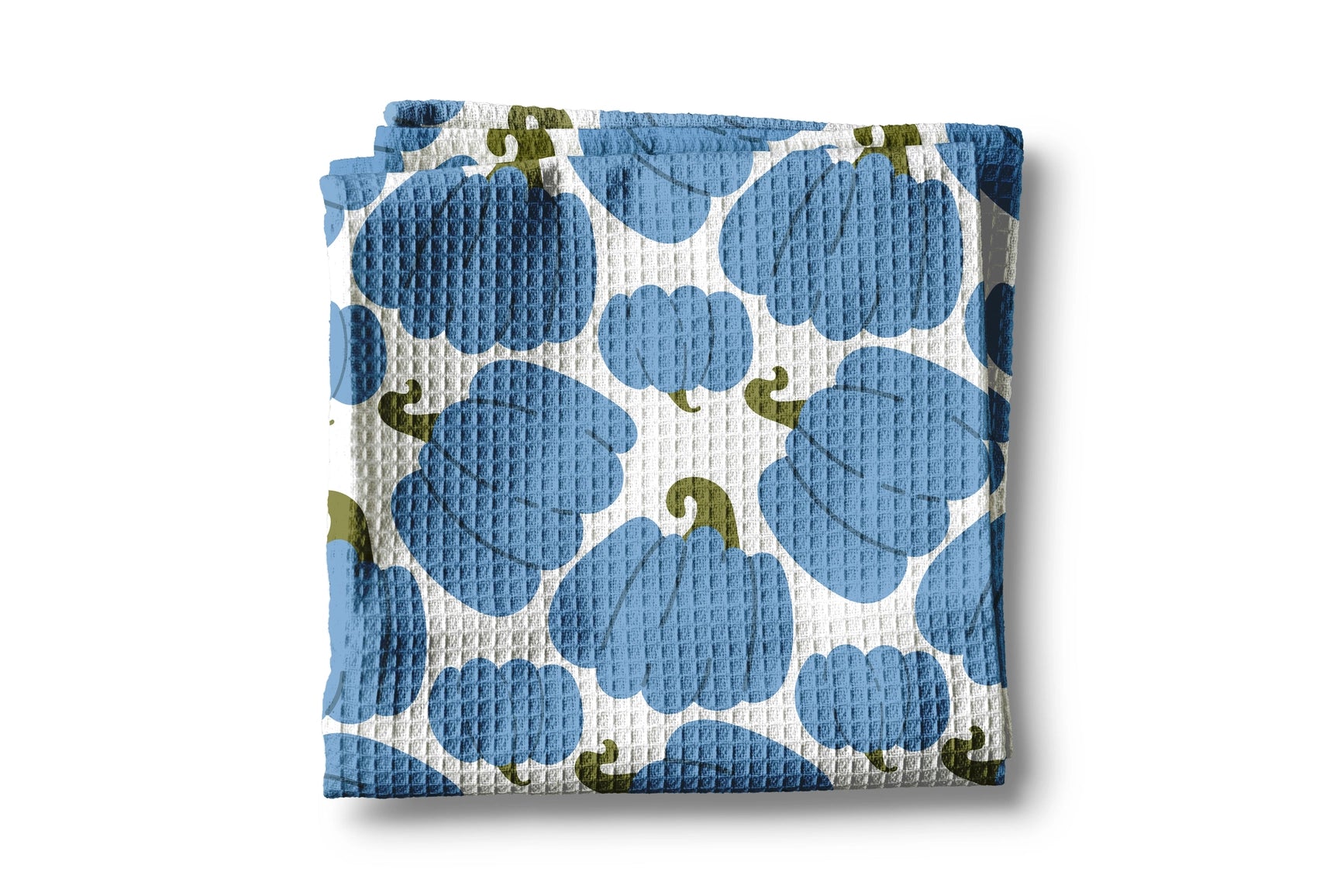 Folded fabric with blue and green pattern on a white background