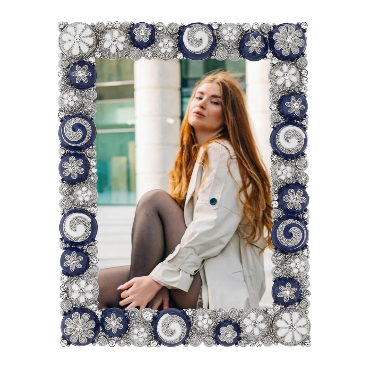 Decorative photo frame with a floral pattern, containing an image of a woman sitting outdoors.
