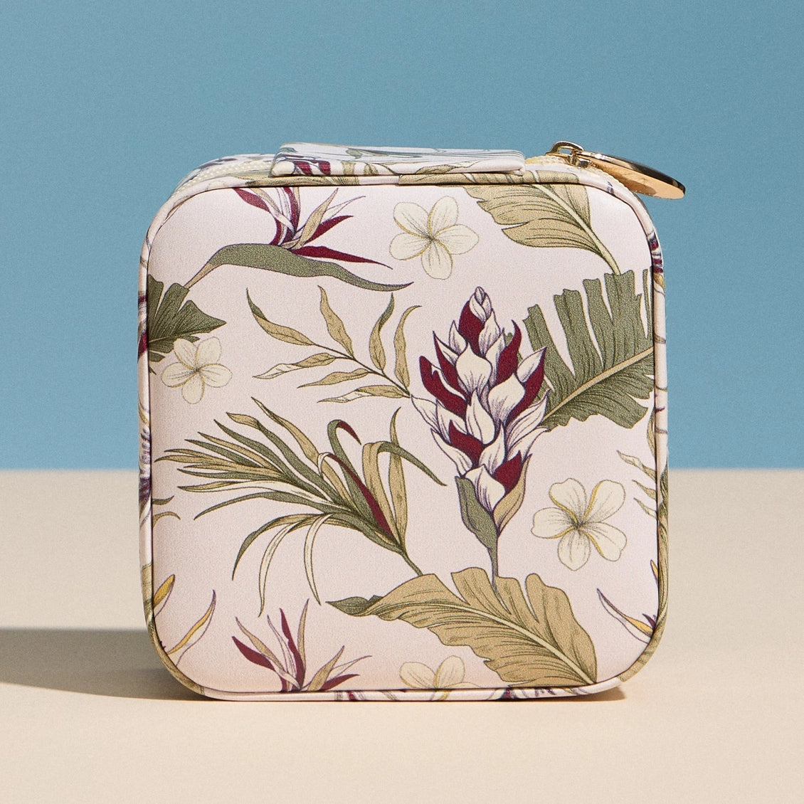 Small rectangular pouch with floral pattern on a blue and beige background