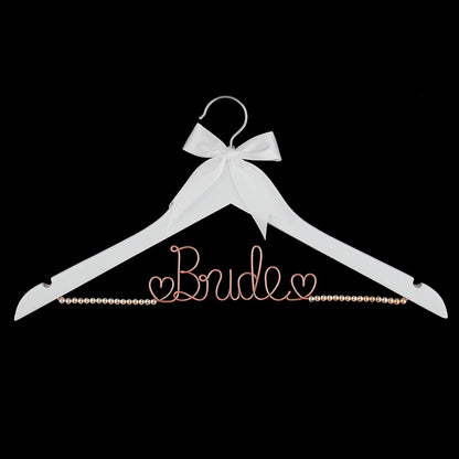 White hanger with 'Bride' text and bow on a black background