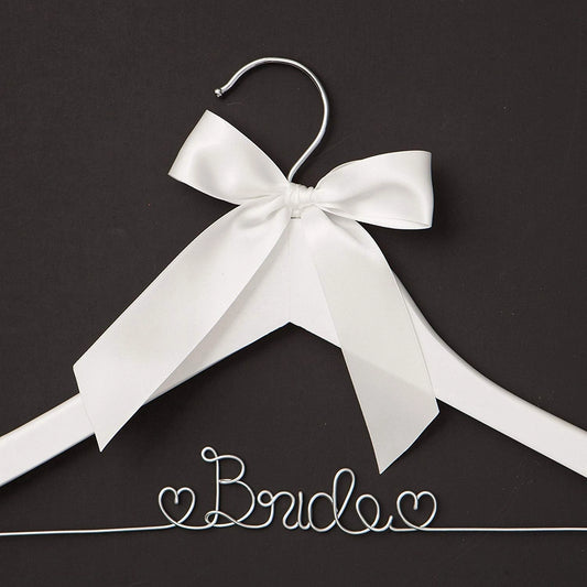 White hanger with a large white bow on a black background