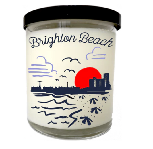 Candle with 'Brighton Beach' design on a white background