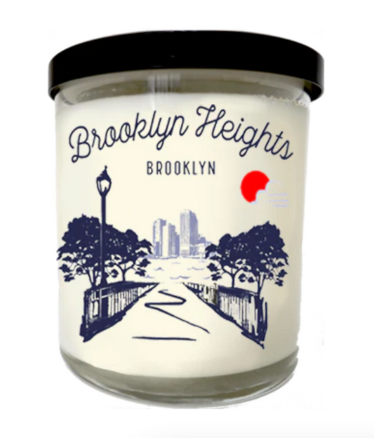 Candle with 'Brooklyn Heights, Brooklyn' label and scenic design on a white background