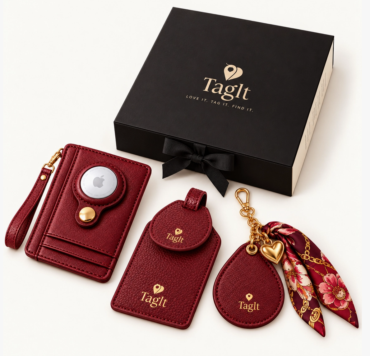 Burgundy wallet, luggage tag, and floral scarf keychain displayed with a black signature gift box.