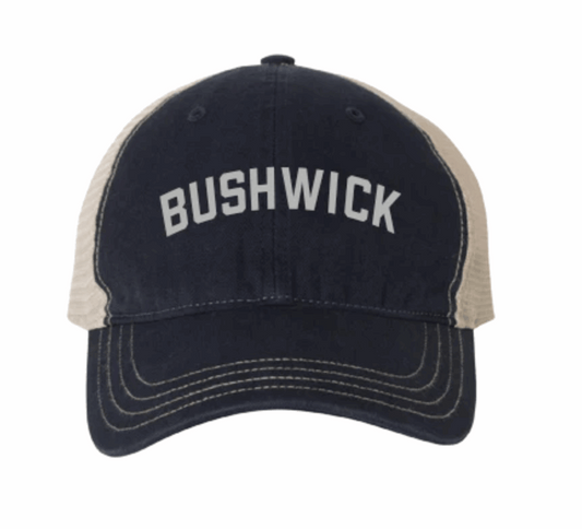 Navy and beige cap with 'BUSHWICK' text on a white background
