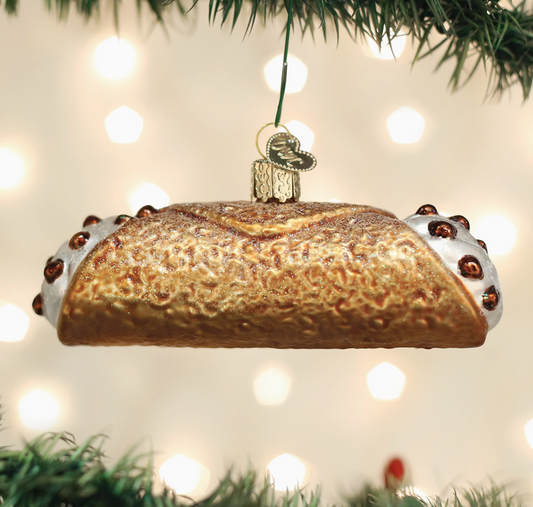 Decorative bread ornament hanging on a Christmas tree with lights in the background