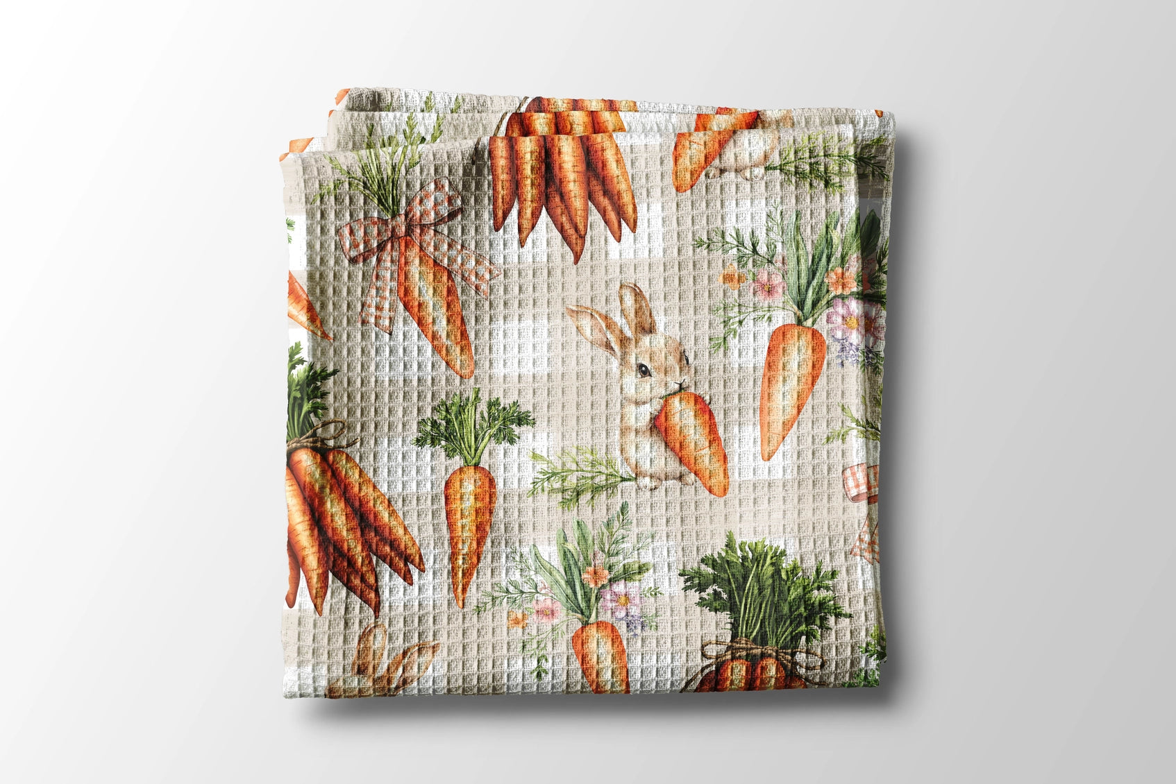 Waffle-textured blanket with carrot pattern on a light gray background