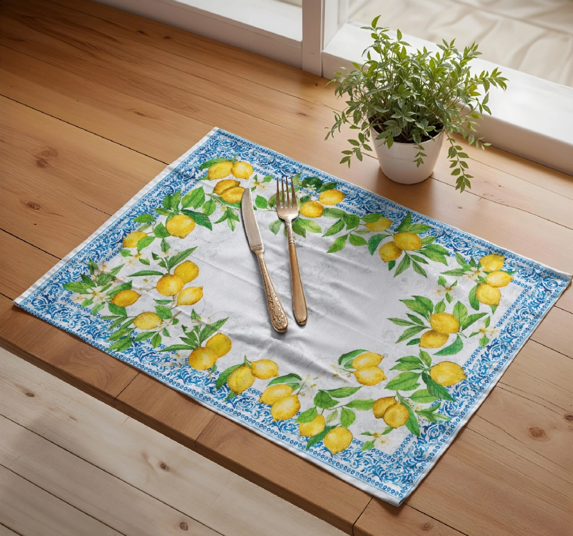 Decorative placemat with lemon design on a wooden floor with cutlery and a plant.