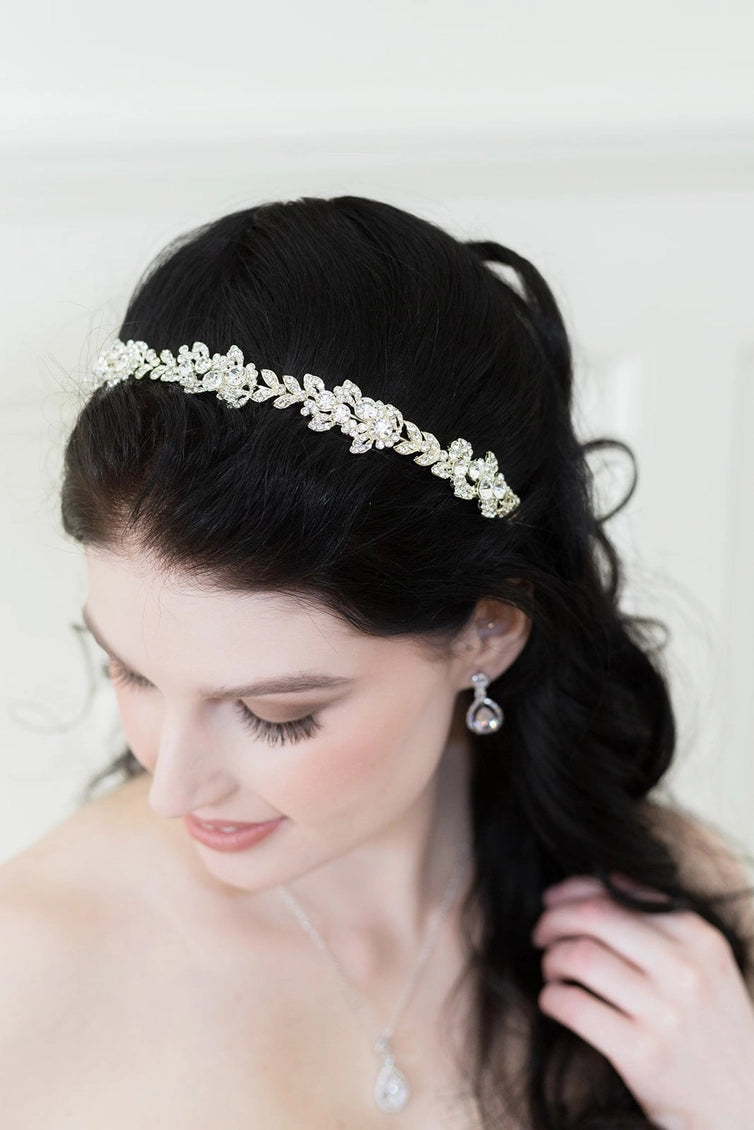 Woman wearing a decorative headband with a plain background