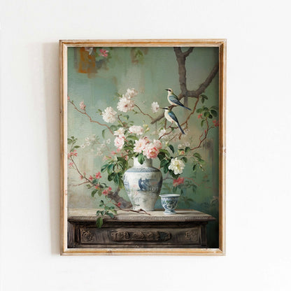 Framed painting of birds and flowers on a table with a vase.