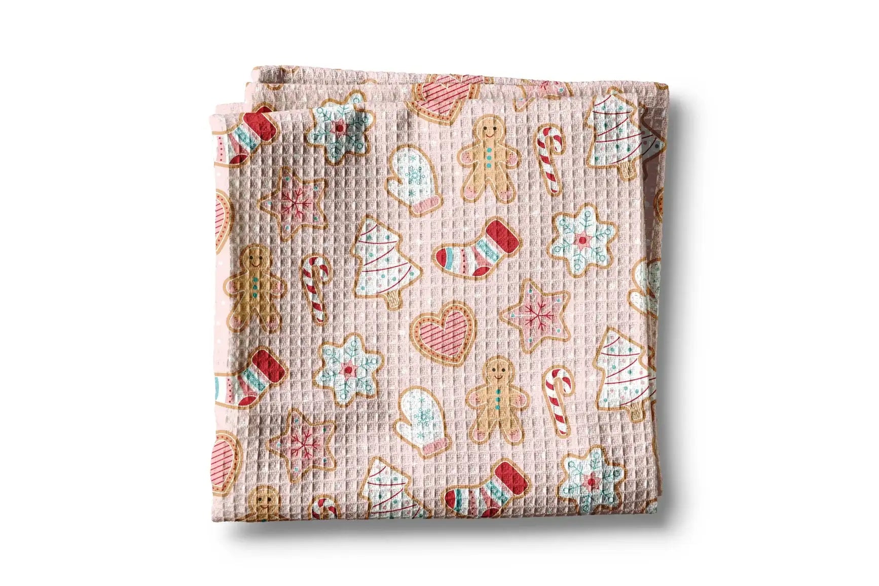 Folded fabric with Christmas-themed cookies pattern on a white background
