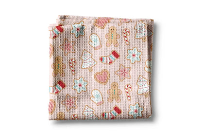 Folded fabric with Christmas-themed cookies pattern on a white background
