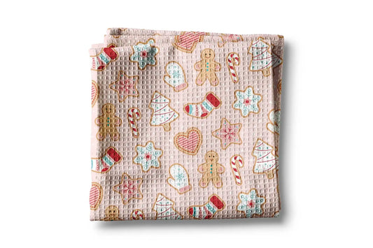 Folded fabric with Christmas-themed cookies pattern on a white background