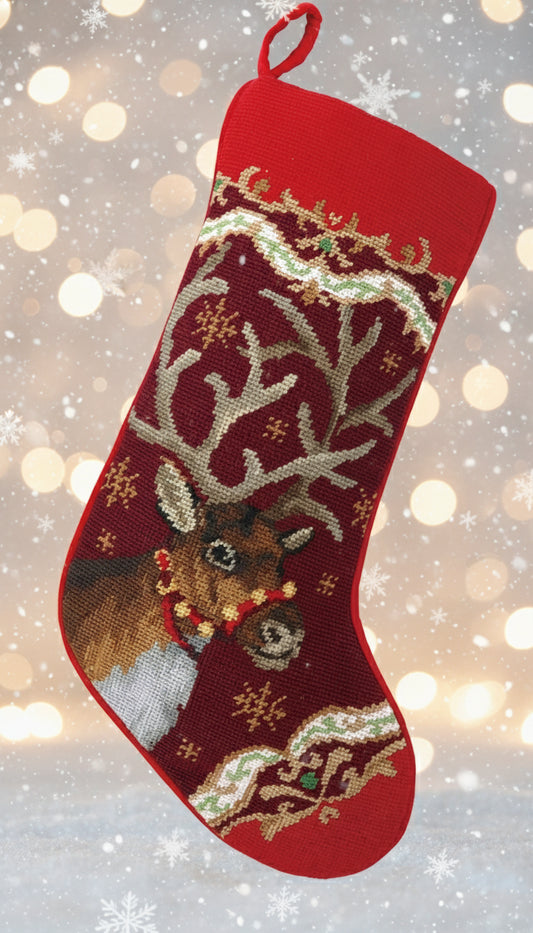 Red Christmas stocking with reindeer design on a white background