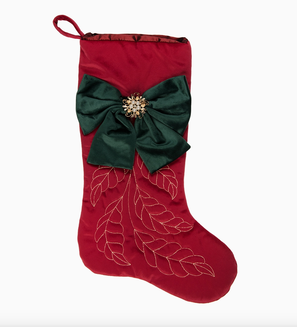 Red Christmas stocking with oversized green bow, jeweled pearl center and gold embroidered leaf design